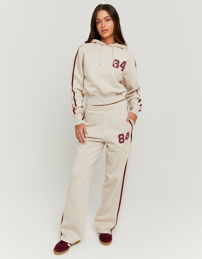 Gestreifte beige Jogginghose mit Print