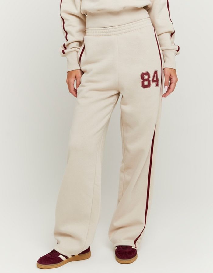 Gestreifte beige Jogginghose mit Print